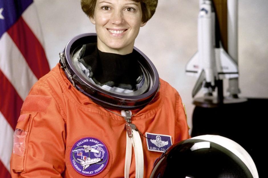 An astronaut portrait with a spacecraft model, illustrating curiosity and exploration.